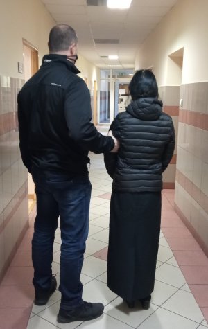 policjant prowadzi zatrzymaną